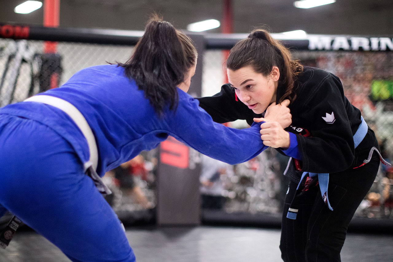 Two female members practice brazilian jiu-jitsu